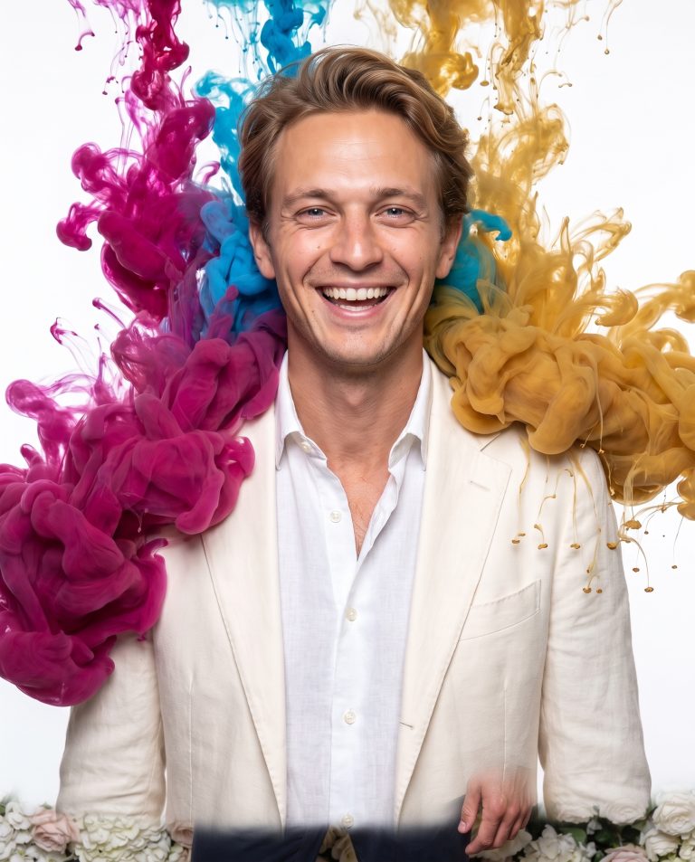 A guest against a clean white ground as enormous plumes of colored ink bloom through the air around them.