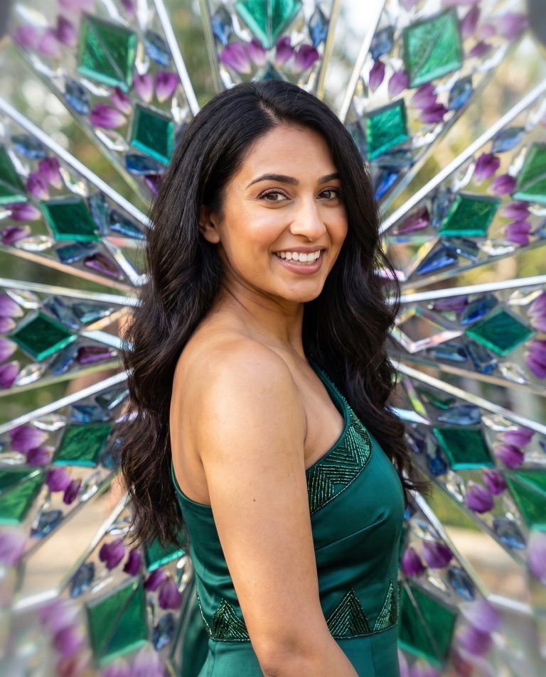 A guest centered in a perfectly symmetrical kaleidoscopic mandala of their own mirrored surroundings.