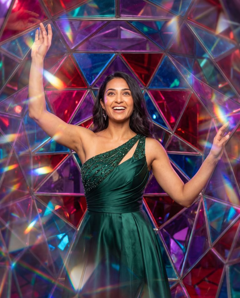 A guest centered in a perfectly symmetrical kaleidoscopic mandala of their own mirrored surroundings.