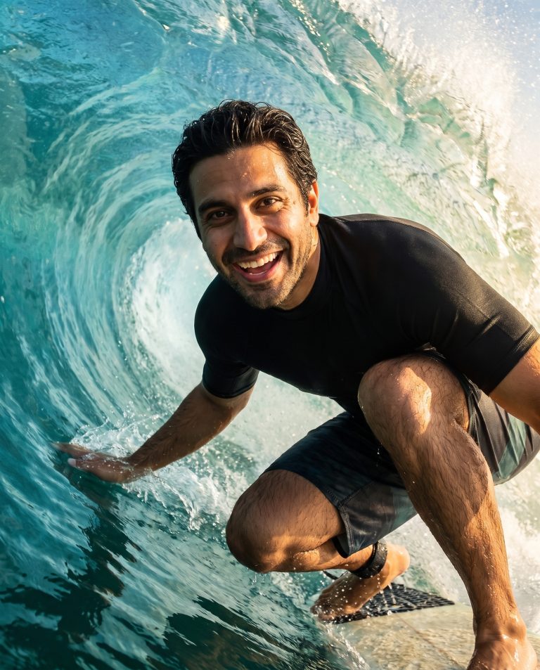 A guest is surfing deep inside a barreling wave, crouched low.