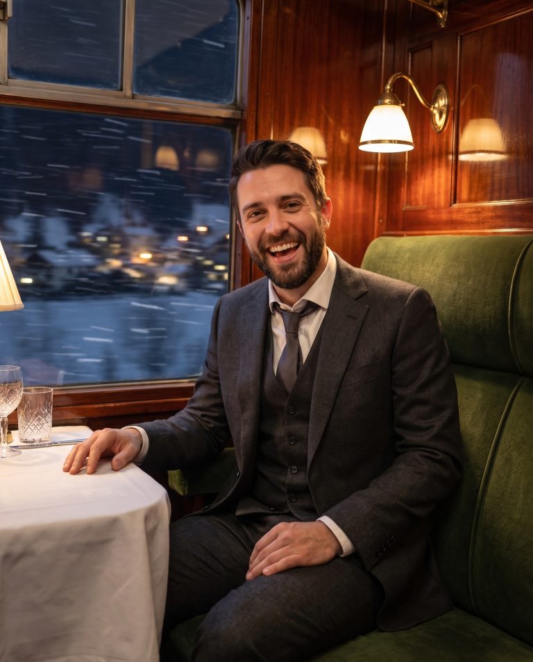 A guest is inside a vintage luxury railway carriage at night, polished mahogany panelling.