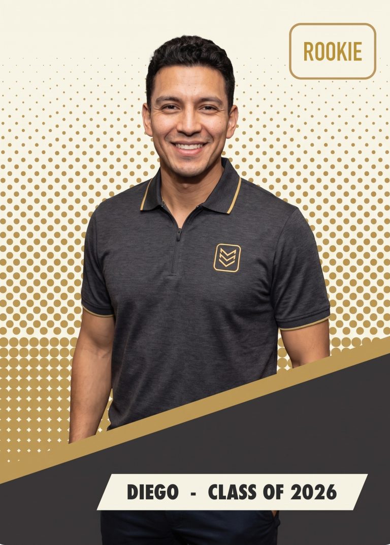 A cream, black and gold company card of a man in a charcoal polo with a gold chevron badge, tagged ROOKIE and CLASS OF 2026