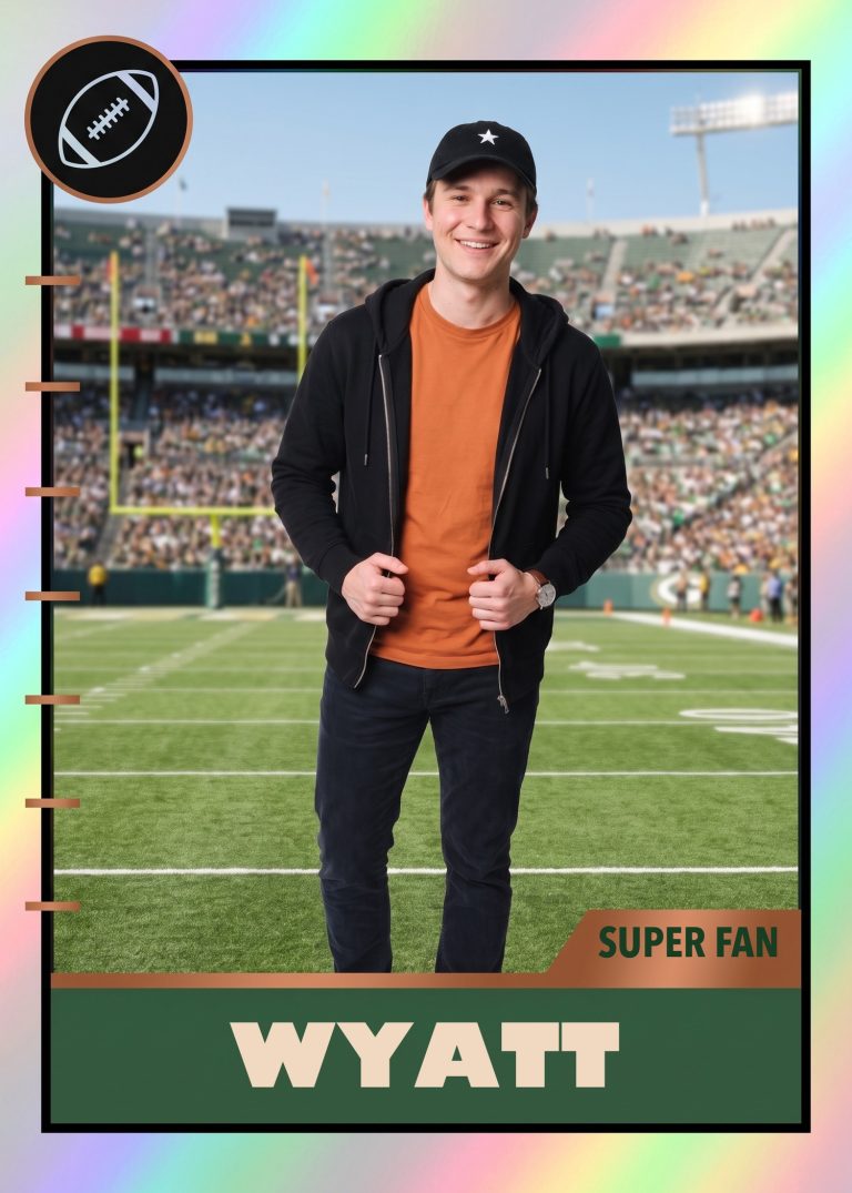 A football card of a man in a black hoodie, orange T-shirt and black ballcap standing at midfield in a full stadium, with a green nameplate