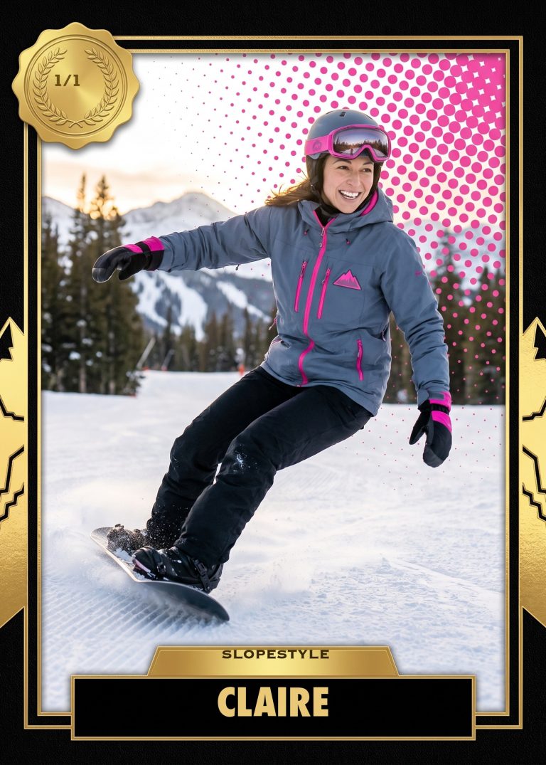 A black and gold action-sports card of a woman in a gray and pink jacket, helmet and goggles carving on a snowboard down a mountain run