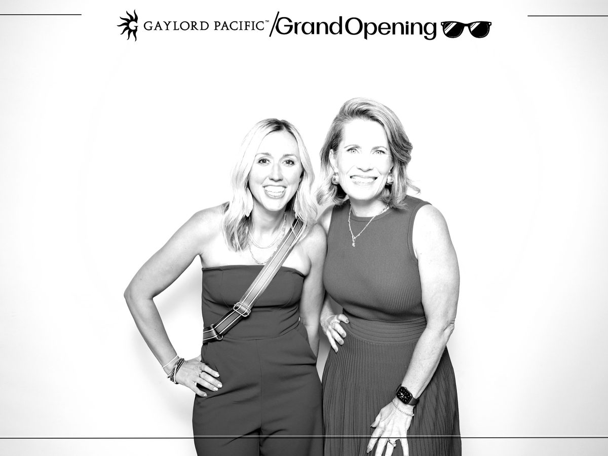 Two guests in a black-and-white glam portrait under a Gaylord Pacific Grand Opening header