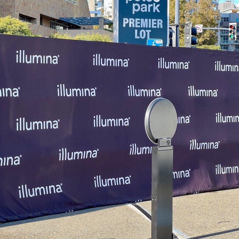 A ring-light open-air booth in front of a step-and-repeat backdrop beside the Petco Park Premier Lot sign