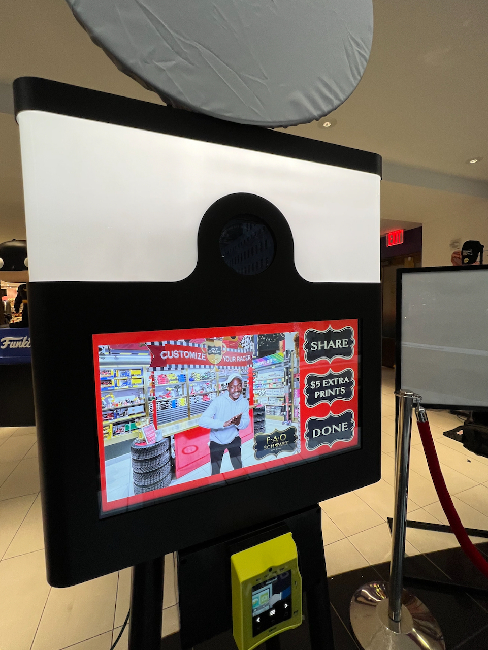 Studio Booth XL touchscreen running a custom FAO Schwarz-branded photo experience with share and print options